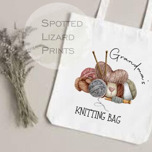 May include: White tote bag with a watercolor illustration of yarn balls, knitting needles, and the words "Grandma's Knitting Bag." The bag has a simple design, perfect for carrying knitting supplies.