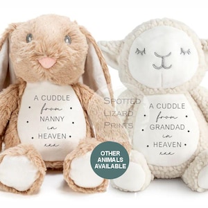May include: A tan plush rabbit and a cream plush lamb, both featuring white embroidered belly patches. The rabbit patch reads A CUDDLE from NANNY in HEAVEN xxx. The lamb patch reads A CUDDLE from GRANDAD in HEAVEN xxx. Text overlays include SPOTTED LIZARD PRINTS and OTHER ANIMALS AVAILABLE.