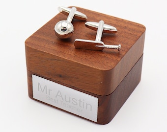 May include: Silver cricket cufflinks in a wooden box with a personalized inscription that reads "Mr. Austin Best Teacher".