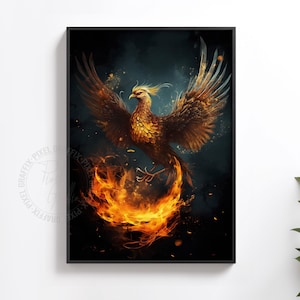 May include: A framed wall art print featuring a phoenix with golden and brown feathers, wings spread wide against a dark background. The bird is surrounded by swirling orange and yellow flames at the bottom, with glowing embers floating in the air.