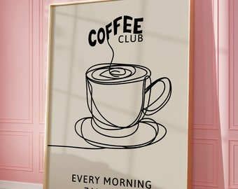 以下が含まれることがあります： コーヒーカップの黒の線画と「COFFEE CLUB」と「EVERY MORNING 7AM - 10AM」のテキストが書かれた、金色の額縁に入ったプリントです。