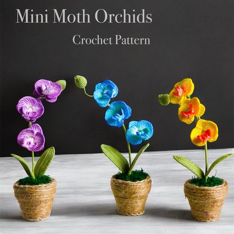 May include: Three crocheted mini moth orchids in pots. The orchids are purple, blue, and yellow. The pots are made of brown twine.