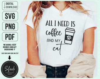 May include: White t-shirt with black text that reads "All I need is coffee and my cat". A black and white illustration of a coffee cup with a paw print on it is next to the text.