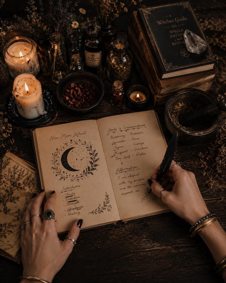 May include: An open journal with the text "New Moon Ritual" and handwritten notes on herbs and intentions. The image includes candles, books, and bottles, creating a mystical and spiritual theme. A hand with rings is writing with a feather.
