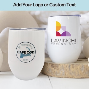 May include: Two white stainless steel wine tumblers with lids. The tumbler on the left has a blue and white logo that says "St. Hoosette Cape Cod 2024". The tumbler on the right has a colorful geometric logo and the text "LAVINCHI TECHNOLOGY".