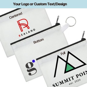 May include: Three white zippered pouches with different designs. The first pouch has a red "R" with the text "REALAND" below it. The second pouch has a black "g" with a blue dot. The third pouch has a black triangle with a green triangle inside and the text "SUMMIT POIN est. 2020" below it.