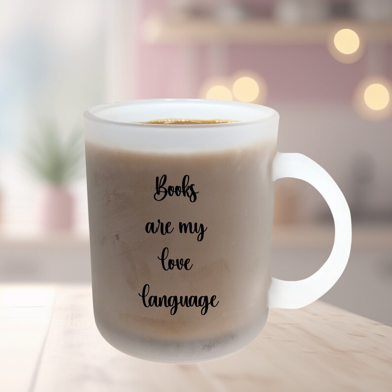 May include: White frosted mug with a black inscription that reads "Books are my love language".