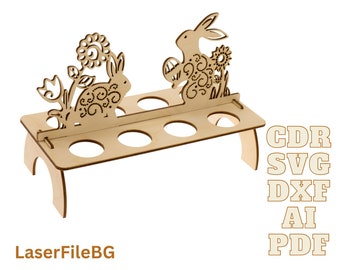 May include: Wooden Easter egg holder with two bunny silhouettes and floral designs. The holder has six egg slots and a stand. The text "CDR SVG DXE AI PDF" is printed on the right side of the image.