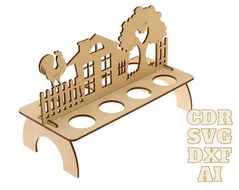 May include: Wooden egg holder shaped like a farmhouse with a rooster, tree, and fence. It has six slots for eggs. The holder is made of light brown wood and is perfect for displaying eggs on a table or countertop.