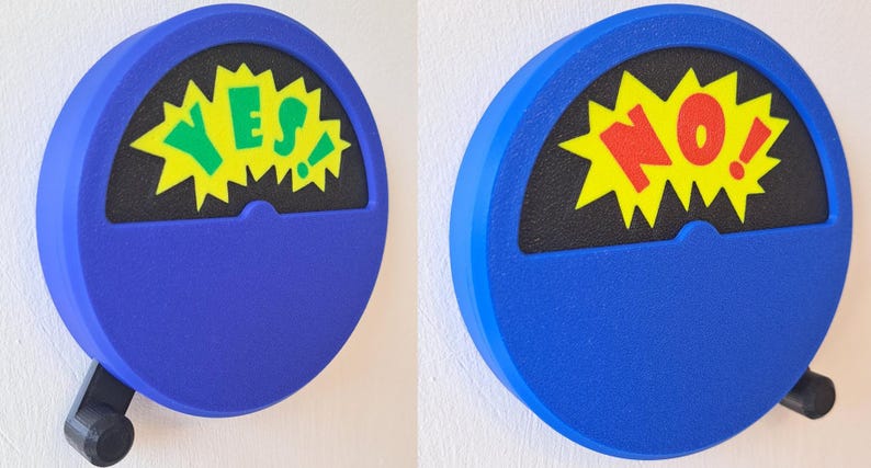 May include: A blue, round, wall-mounted, spinning decision maker with a black background and a yellow starburst. The starburst has the word "YES" in green letters on the left and the word "NO" in red letters on the right.