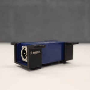 May include: A blue and black audio interface with a single XLR input and a warning label that reads "HEADPHONE JACK - HIGH VOLTAGE".