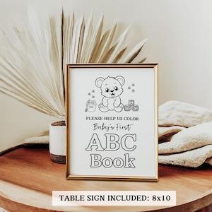 May include: Black and white printable sign with a cute cartoon bear holding a block. The sign says "Please help us color Baby's First ABC Book". Table sign included: 8x10