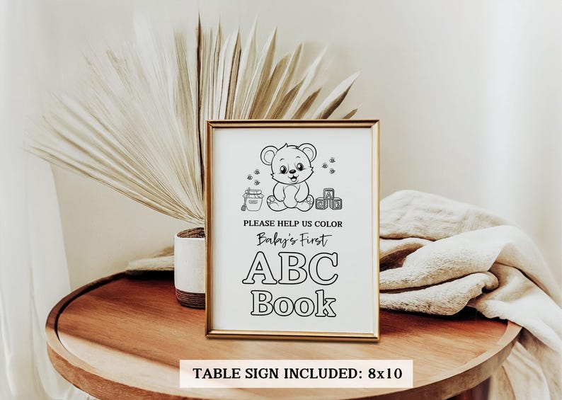 May include: Black and white printable sign with a cute cartoon bear holding a block. The sign says "Please help us color Baby's First ABC Book". Table sign included: 8x10