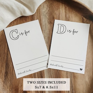 May include: Two printable cards with the letters "C" and "D" and the text "C is for" and "D is for". The cards are on a wooden surface. The text "Made with love by..." is at the bottom of each card. The text "TWO SIZES INCLUDED 5x7 & 8.5x11" is at the bottom of the image.