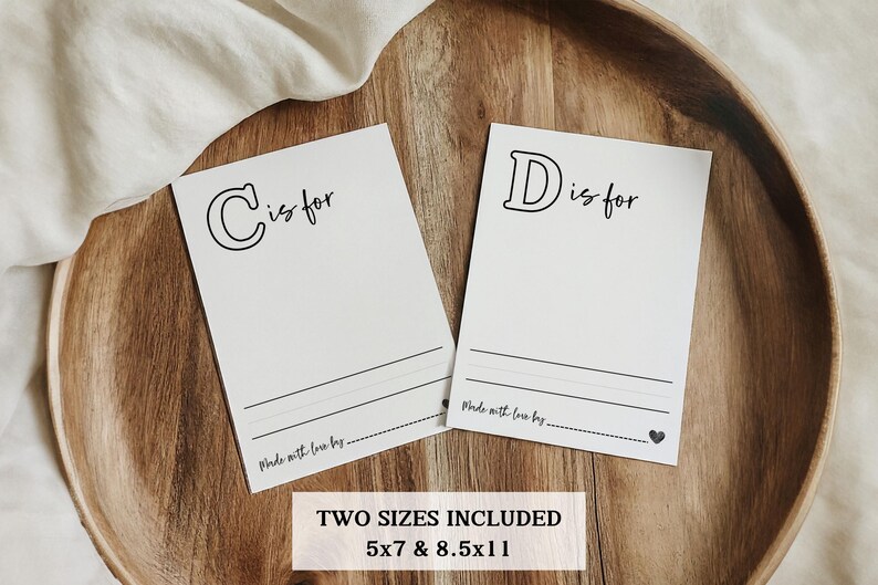 May include: Two printable cards with the letters "C" and "D" and the text "C is for" and "D is for". The cards are on a wooden surface. The text "Made with love by..." is at the bottom of each card. The text "TWO SIZES INCLUDED 5x7 & 8.5x11" is at the bottom of the image.