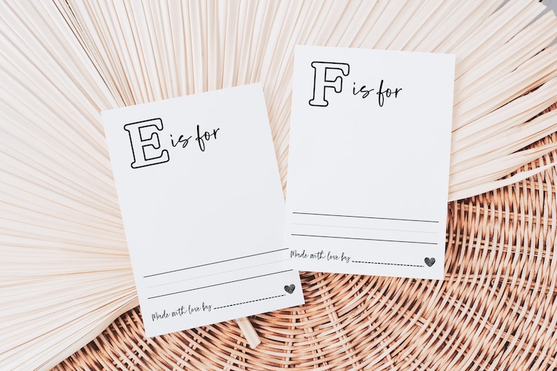 May include: Two white cards with black outlines of the letters E and F. The text "is for" is written next to each letter. The cards have a line for writing and the text "Made with love by..." at the bottom.