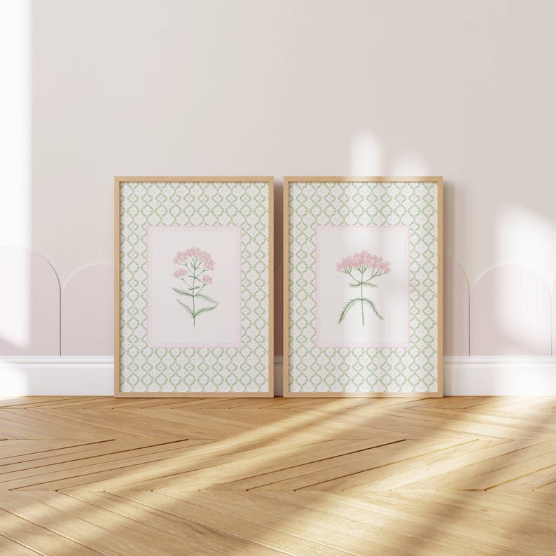 May include: Two framed prints with a green and white geometric pattern border. Each print features a pink flower with green stems and leaves on a white background.