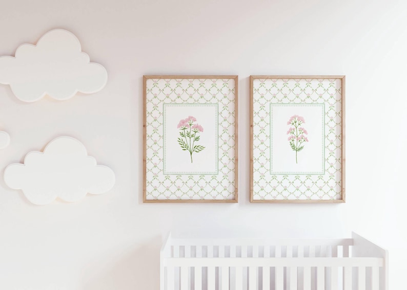 May include: Two framed prints with a white background and a green and gold patterned border. Each print features a pink flower with green leaves.