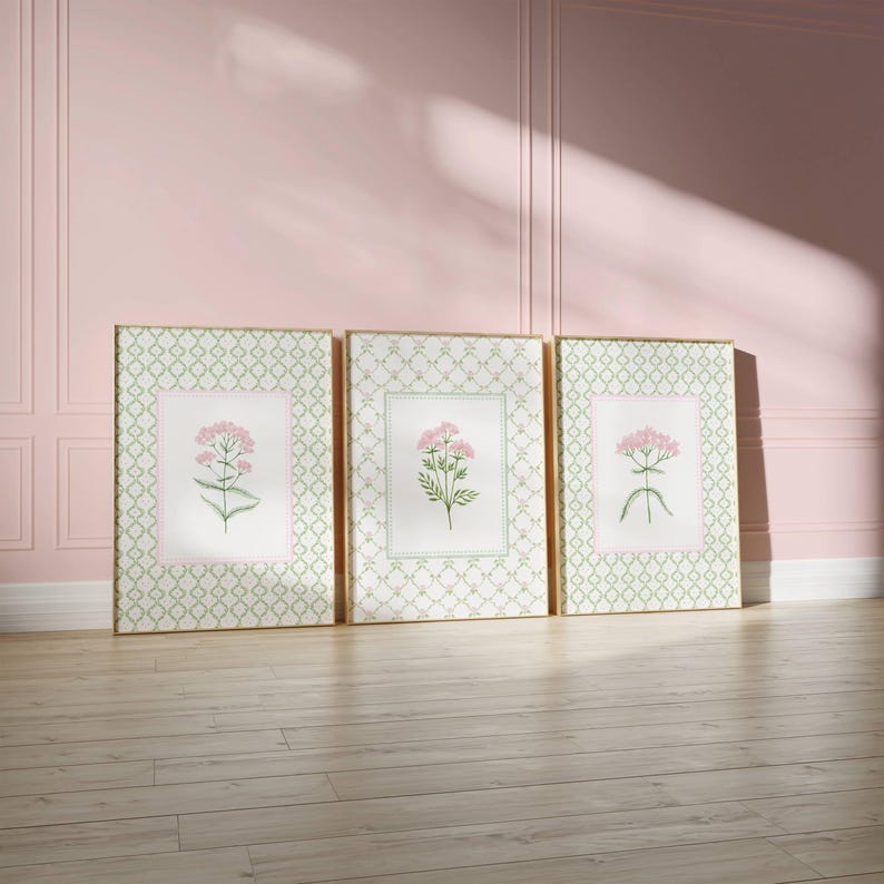 May include: Three framed prints with a green and white geometric pattern. Each print features a pink flower with green leaves on a white background.