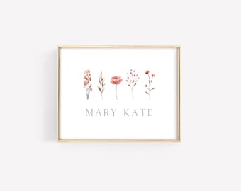 May include: A gold framed print with a watercolor illustration of five pink flowers and the text "MARY KATE" in black.
