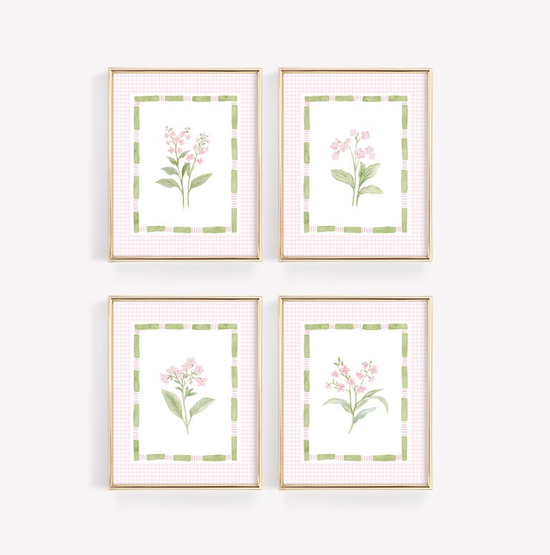 May include: Four framed floral art prints. Each print features a watercolor illustration of pink flowers with green leaves. The artwork is set against a pink and white gingham background, framed with a gold border and green accents.