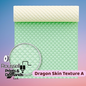 May include: A green, textured sheet with a dragon scale pattern, with a cream-colored roller at the top. The text "Dragon Skin Texture A" is displayed in a pink banner. A magnifying glass shows a close-up of the pattern. The logo for Roussell Prints & Demands LLC is in the lower left.
