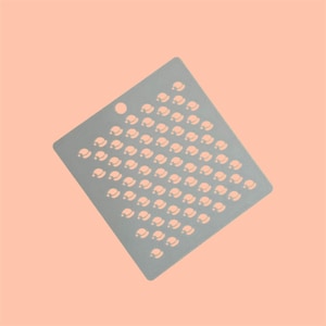 May include: A gray square kitchen scrubby with a pattern of small, white, Christmas hat shapes.