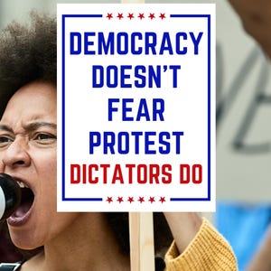 May include: A person holding a sign with the words "DEMOCRACY DOESN'T FEAR PROTEST DICTATORS DO" in blue and red text. The sign is framed in blue with red stars at the top and bottom. The person is yelling.