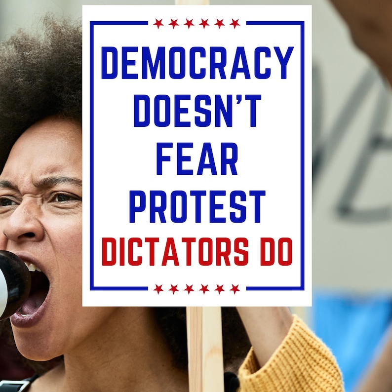 May include: A person holding a sign with the words "DEMOCRACY DOESN'T FEAR PROTEST DICTATORS DO" in blue and red text. The sign is framed in blue with red stars at the top and bottom. The person is yelling.