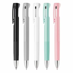 May include: Five multi-coloured retractable pens with black ink. The pens are black, grey, white, light blue, and pink.