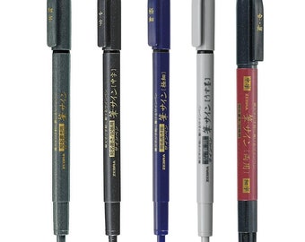 May include: Five black, blue, gray, and red ink pens with gold lettering. The pens are labeled "Zebra Brush Sign" and have different Japanese characters on them. The pens are for writing and calligraphy.