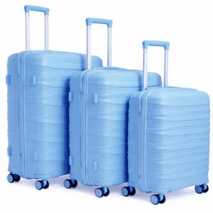 May include: Three light blue rolling suitcases of different sizes. Each suitcase has a retractable handle, four wheels, and a textured surface. The luggage is designed for travel and is set against a white background.