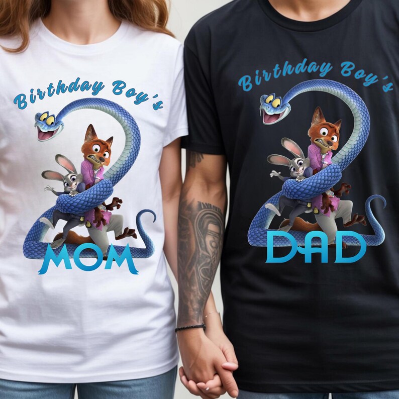 May include: A white t-shirt and a black t-shirt featuring a graphic of a blue snake shaped like the number two, wrapped around a cartoon fox and rabbit. The text reads Birthday Boy's MOM on the white shirt and Birthday Boy's DAD on the black shirt.