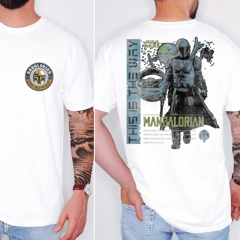 May include: A white t-shirt featuring a circular chest graphic with a helmet and the text DADALORIAN NUMBER ONE IN THE GALAXY. The back displays a large graphic of a armored character, a small creature in a pod, and the text THIS IS THE WAY.