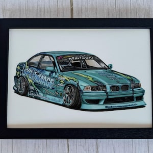 May include: A framed illustration of a light blue drift car featuring yellow flame graphics, the text SPLITMAGE on the side, and MATSURI on the windshield. The car has a lowered stance, wide wheels, and a front bumper with a black grille and headlights.