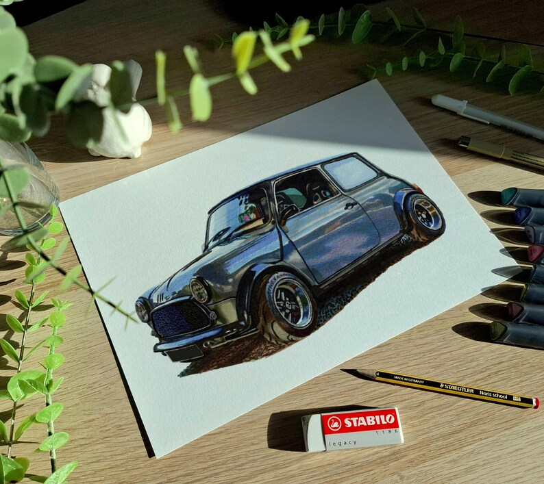 May include: A detailed color drawing of a classic compact car on white paper. The vehicle is depicted in a dark blue hue with wide wheel arches, chrome-rimmed wheels, and a prominent front grille. The artwork captures realistic light reflections.