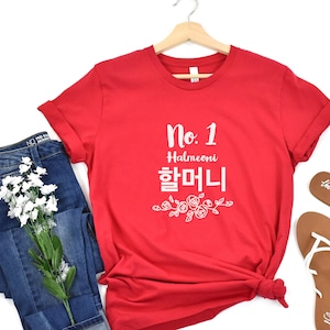May include: Red t-shirt with white text that says "No. 1 Halmeoni 할머니" with a floral design underneath.