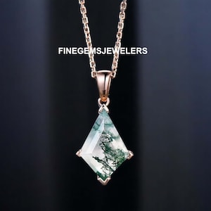 May include: A rose gold necklace featuring a geometric pendant. The pendant is a clear gemstone with green inclusions, set in a rose gold frame. The chain is delicate and the pendant is diamond-shaped. The text "FINEGEMSJEWELERS" is visible.