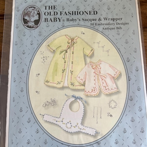 May include: A vintage baby embroidery pattern titled "The Old Fashioned Baby" featuring designs for a sacque, wrapper, and antique bib. The cover shows illustrations of the garments in pastel colors with floral accents.