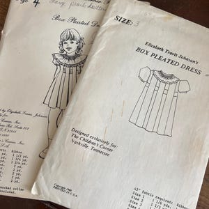 May include: Two vintage sewing patterns for children's box pleated dresses. One pattern is size 4, the other is size 3. The patterns feature illustrations of the dress and include fabric and ribbon requirements. The Children's Corner, Nashville, Tennessee.