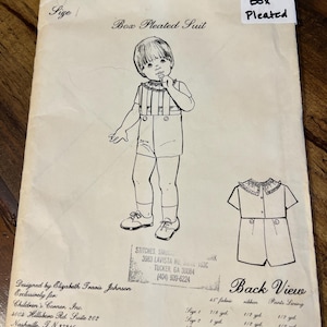 May include: Vintage sewing pattern for a box pleated suit from The Children's Corner Patterns. The pattern includes a line drawing of the suit and a back view diagram. Designed by Elizabeth Travis Johnson, printed in the U.S.A.