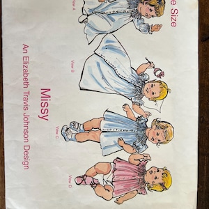 May include: A vintage sewing pattern titled "Missy" by Elizabeth Travis Johnson Design. The pattern features illustrations of babies in various outfits, including a blue dress, a pink dress, and a white gown. The pattern is labeled "One Size."