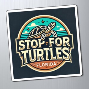 May include: A black and white sticker with a colorful logo. The logo features a sea turtle with the text "STOP FOR TURTLES - FLORIDA".
