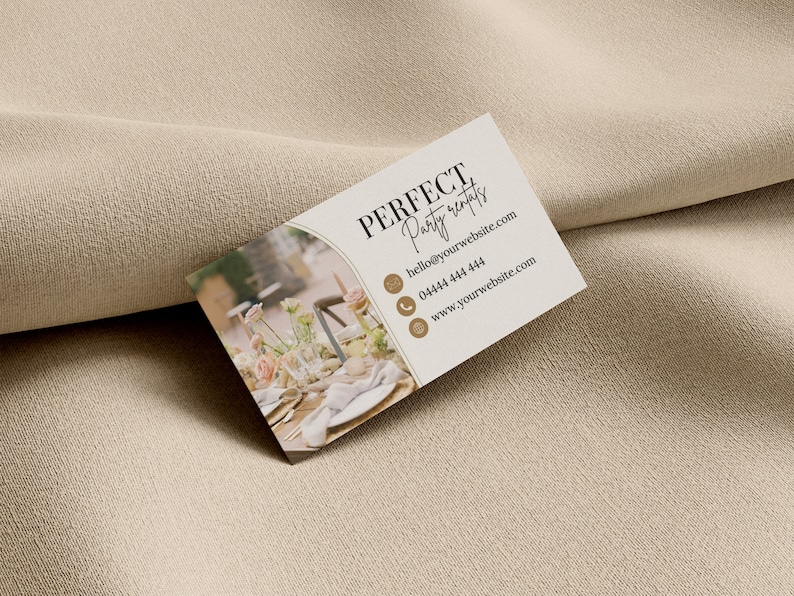 May include: A white business card with brown text that reads "PERFECT Party rentals" with contact information including an email address, phone number, and website address. The background of the card features a blurred image of a table setting with flowers and candles.