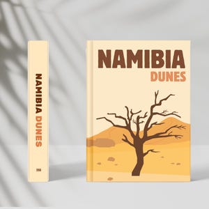Puede incluir: Un libro titulado "Namibia Dunes" con una cubierta beige. La portada presenta una ilustración marrón de un paisaje desértico con un árbol desnudo y el texto "Namibia Dunes" en marrón y naranja. El lomo también muestra el título.