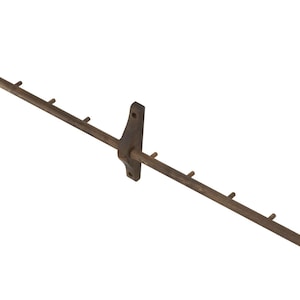 May include: A brown metal coat rack with multiple hooks. The rack is mounted to a wall with two brackets.