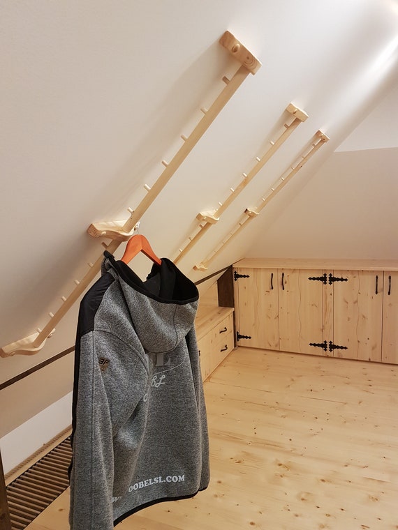 Unique wall-mounted coat rack under a sloped ceiling