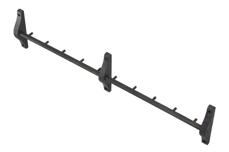 May include: Black metal wall-mounted coat rack with six hooks. The rack is made of metal and has a black finish.