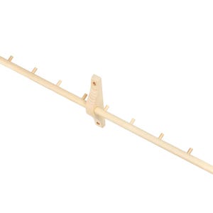 May include: A wooden wall-mounted coat rack with multiple hooks. The rack is made of natural wood and has a simple design.
