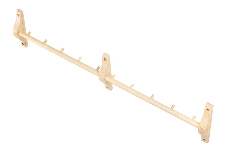 May include: A wooden wall-mounted coat rack with multiple hooks. The rack is made of natural wood and has a simple design.